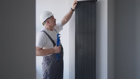 A-man-plumber-checks-the-batteries-and-heating-system.-Heating-season.-Modern-plumber